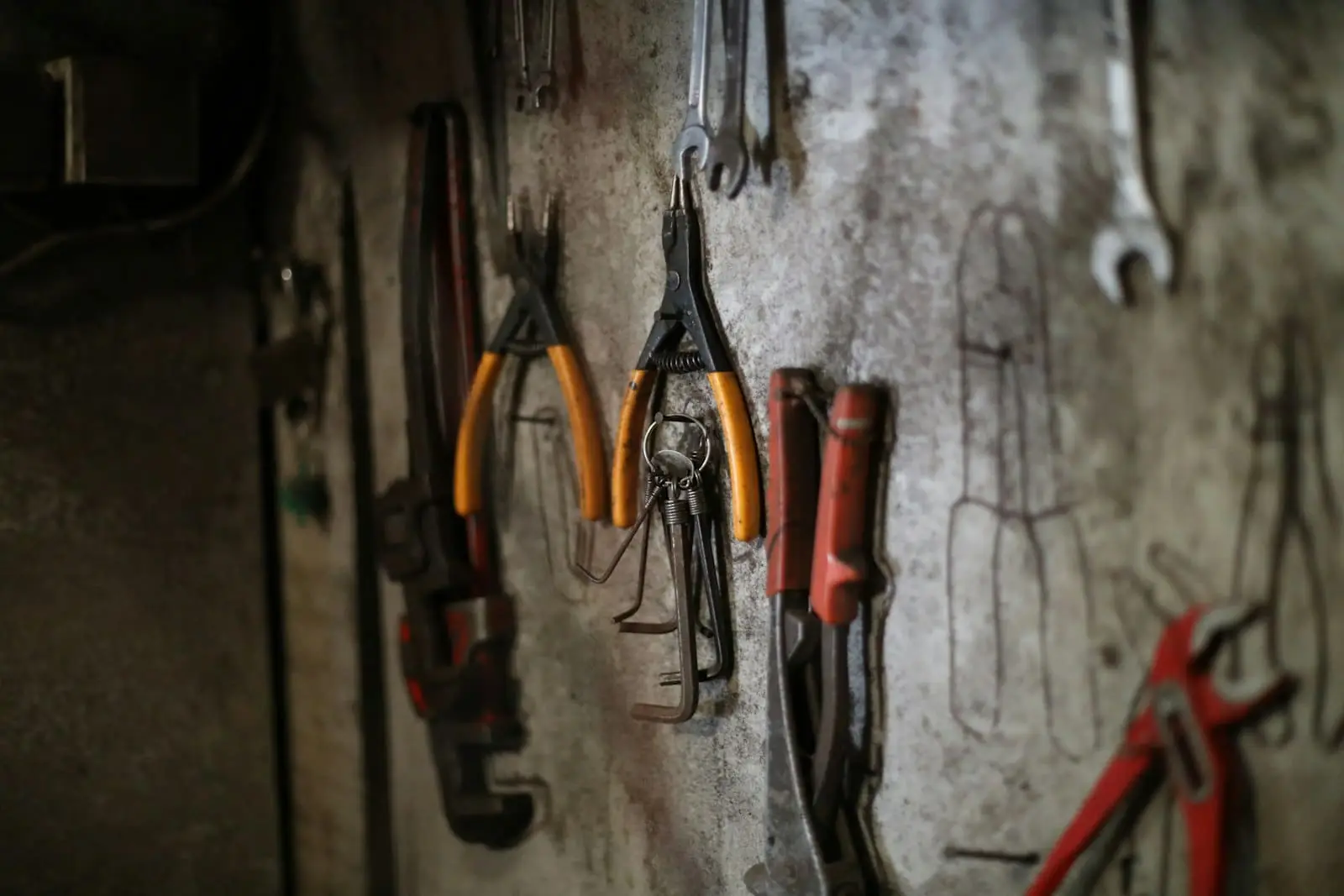 Hand tools hanging on a workshop wall
