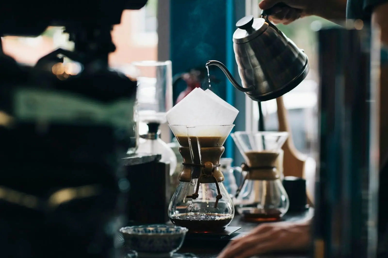 Coffee being poured over into a glass carafe
